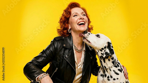 tylish Redhead Woman with Dalmatian Dog on Yellow Background