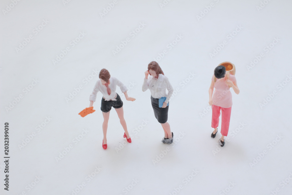 Naklejka premium Miniature people performing daily tasks in group