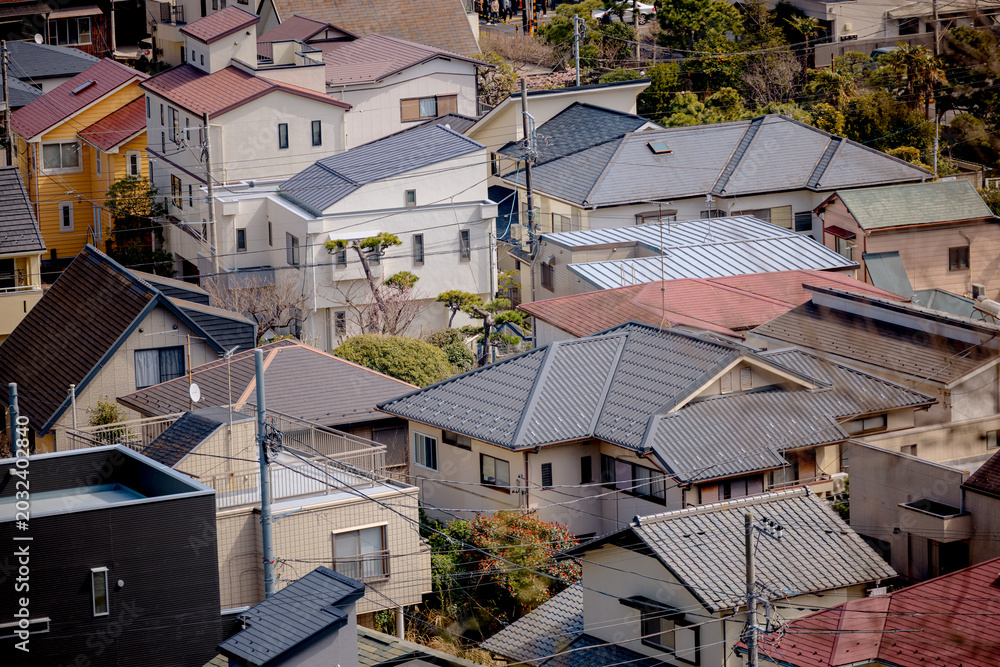 Fototapeta premium Historic temple buildings overlook the city from the elevated grounds of Hasedera Temple in Kamakura, Japan.