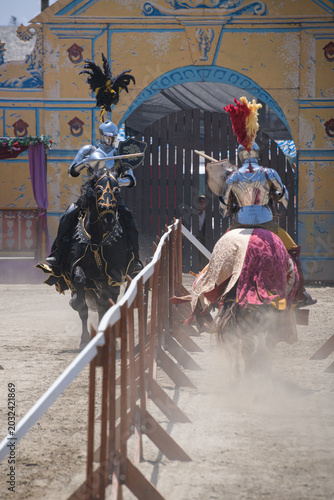 Φωτογραφία Two armored knights charge toward one another during a jousting reenactment at a