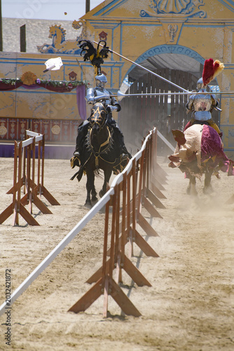 Foto Two armored knights charge toward one another during a jousting reenactment at a