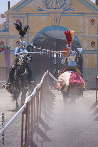 Quadro em tela Two armored knights charge toward one another during a jousting reenactment at a