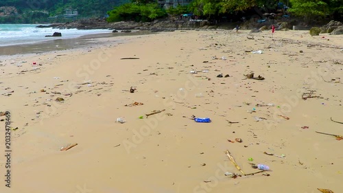 Tropical shoreline overwhelmed by disgusting trash pollution and ocean debris Thailand.