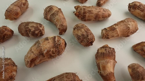 Taro root on white table. Colocasia esculenta.