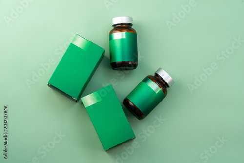 Green supplement bottles and boxes mockup on a clean white background.