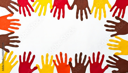 Colorful hand cutouts surrounding a blank space
