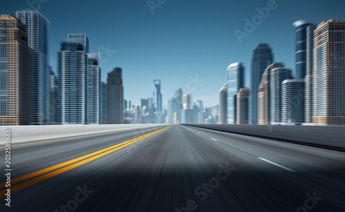 Blurry highway leading to a modern city skyline at dawn with clear blue sky