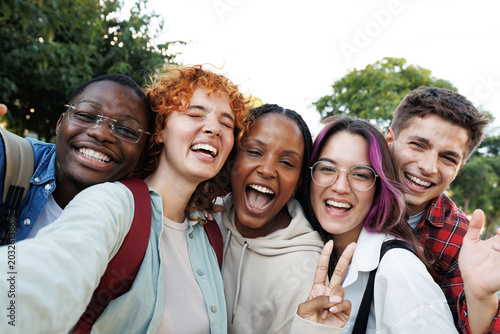 Bild auf Leinwand Happy multi-ethnic students taking selfie outdoors, university campus lifestyle