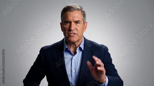 Mature man expressing shock, surprise in business casual attire