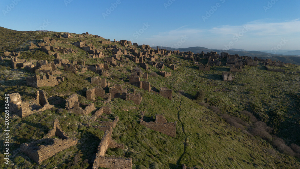 Fototapeta premium Aerial Drone View of Ruined Stone Houses in Abandoned Sazak Village Karaburun