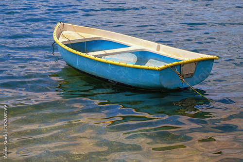 Simple wooden fishing boat, calm water