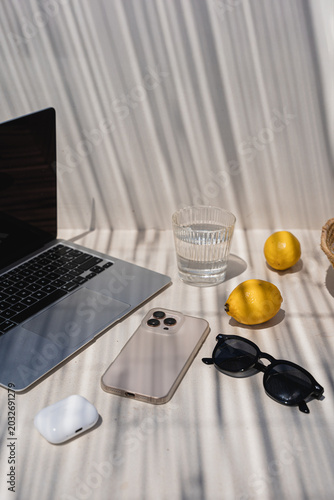 Minimalist Outdoor Workspace Featuring Laptop Smartphone And Refreshing Glass Of Water