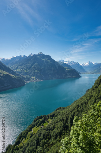 Lake Lucerne in summer with blue skies and the village of Sisikon