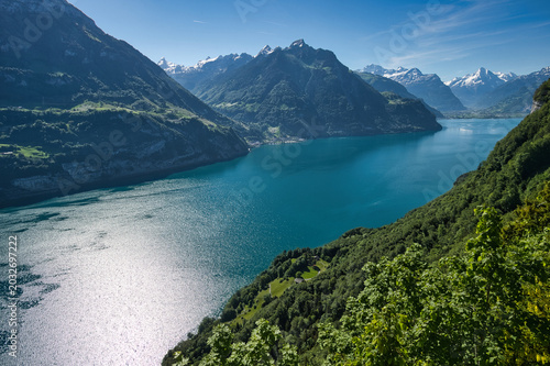 Lake Lucerne in summer with blue skies and the village of Sisikon