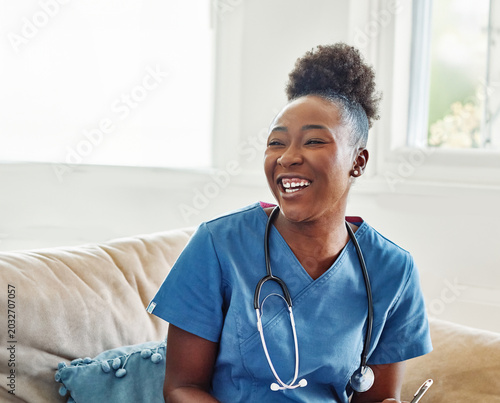 Doctor or nurse caregiver talking to senior man at home or nursing home