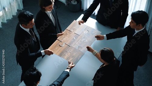 Konstfotografi Top view of skilled businesspeople hand bring and fill the last jigsaw piece together