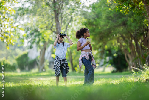 Multicultural Children Exploring Nature with Binoculars During Outdoor Eco Education Activity