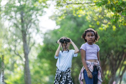Multicultural Children Exploring Nature with Binoculars During Outdoor Eco Education Activity
