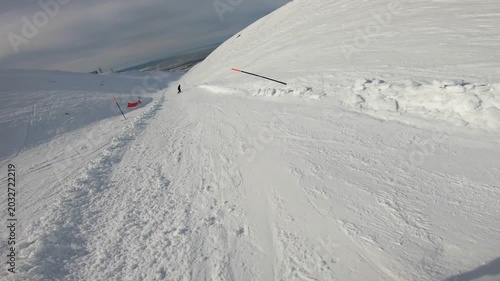 Chilly Alpine Scenery. Frozen Peaks With Snow Trail. Cold Icy Mountains With Snowcovered Pathways. Glistening Frozen Peaks With Windshaped Ice Formations Bordering Icy Mountain Paths And Rugged Cliffs