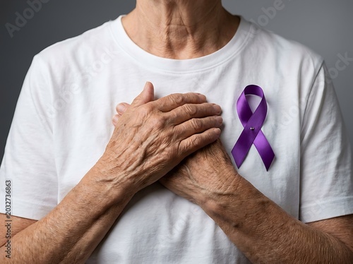 Elderly person's hands over chest with purple awareness ribbon on white shirt world elder abuse awareness day awareness protection wrinkled prevention world elder abuse awareness day
