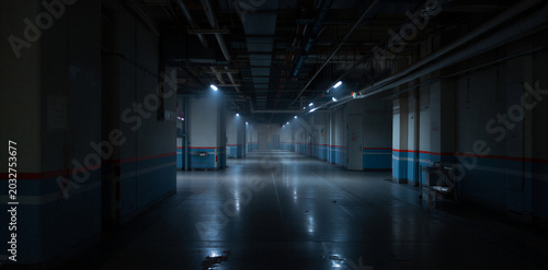 Fotografie Dark empty industrial corridor with blue wall stripes and ceiling lights