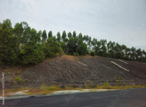 Foto landscape with road 5Overcast sky looms above green embankment