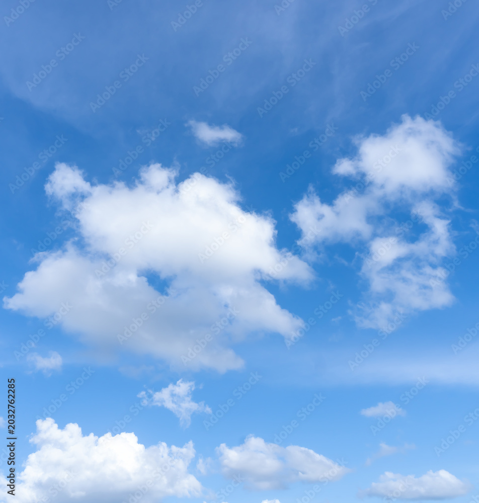 Fototapeta premium Low angle view and full frame of beautiful blue sky with strange shape of fluffy white clouds in the afternoon on sunny day used as natural background texture in decorative art work