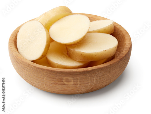 sliced raw potato in wooden bowl isolated on white background. clipping path