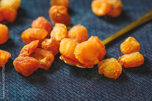 Tableau sur toile Dried Longan Fruit on Dark Fabric with Spoon