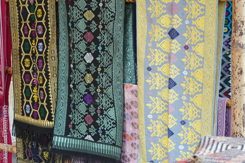 Colorful traditional handwoven fabrics on display.