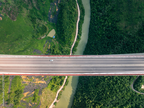 Fotografija Drone shot of a spectacular bridge over a lush green canyon in the mountainous r