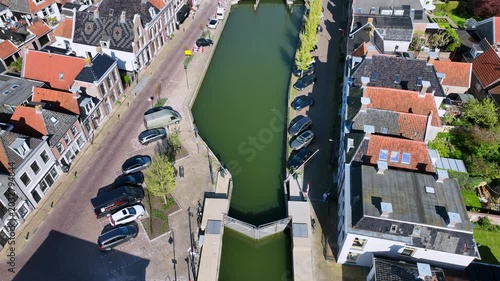 Reveal shot of a historic lakeside town with waterfront in Europe