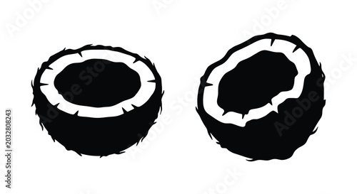 Obraz na płótnie Two halved coconut silhouettes with fibrous husks and dark interiors on a white