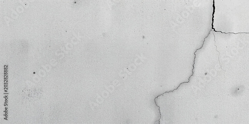Quadro su tela A close-up view reveals a prominent crack on a weathered concrete wall, highlighting texture and imperfections, suggesting decay or damage