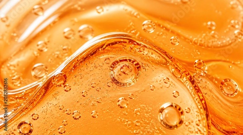Close up of transparent orange cosmetic gel serum background.