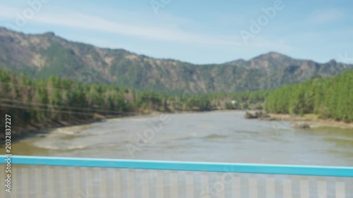 Valley Viewed Distinctly. Scenic River Valley From Bridge. River Crossing With Pine Trees Under Bright Blue Sky. Bridge Viewpoint Overlooking Rural River Valley With Forested Hills And Clear Sky