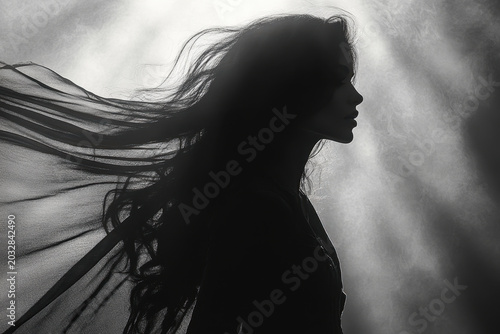 Woman with long hair blowing in the wind.