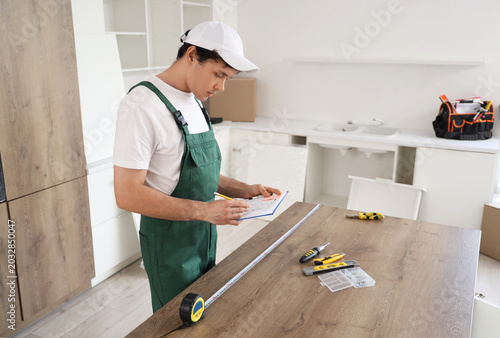 Male worker with plan assem...