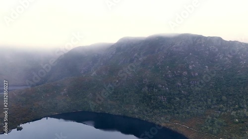 Fog high in Tasmania mountains Dove lake Cradle Mount national park aerial landscape.
