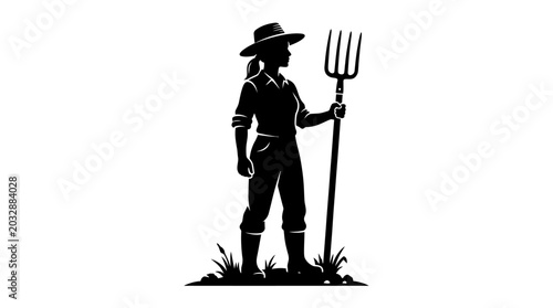 Bild auf Leinwand Silhouette of a female farmer holding a pitchfork in a field.