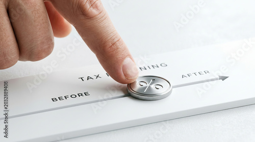 Tax planning tax percent coin finger before after finance saving concept, close up hand sliding percent coin along arrow from before to after white background, careful planning for tax saving