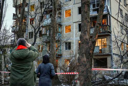 Obraz na plátne People gather around heavily damaged buildings at the site of a devastating Russian missile strike in Kyiv Ukraine as shocked residents and emergency workers survey the catastrophic destruction