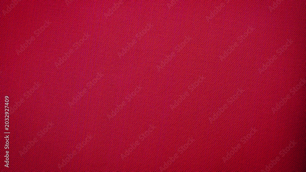 Fototapeta premium Bright red textile fabric showing smooth texture and even color in a close view with no patterns or designs visible