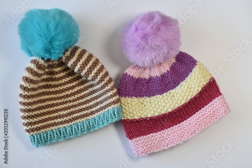 hand knitted pompom hats made from wool an yarn