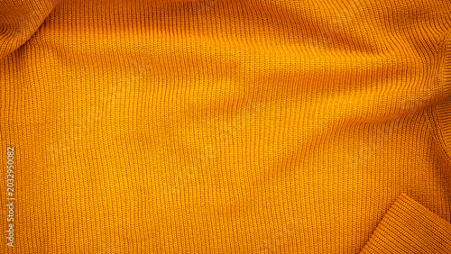 Obraz na plátně Bright orange knit fabric shown up close in natural light on a flat surface duri
