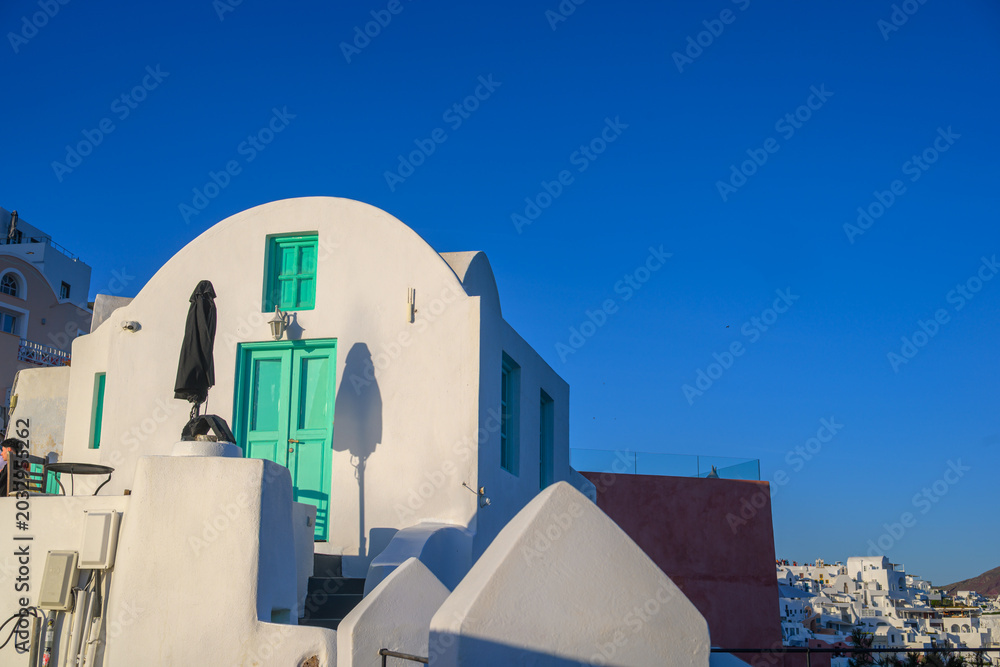 Obraz premium Cycladic house with green shutters in Oia