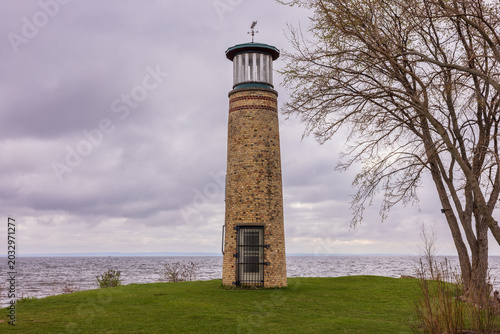 A Lighthouse On A Small Island On A Lake