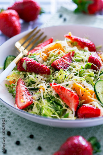 Salad with young cabbage and strawberries.