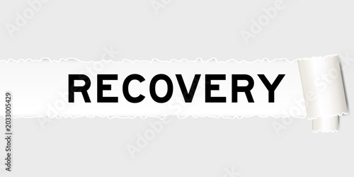 Ripped gray paper background that have word recovery under torn part
