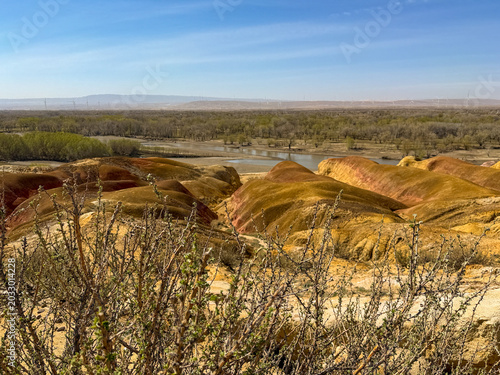 Stunning landscape of Wucaitan (Five Colored Hills) and the Irtysh River in Burqin, Xinjiang, China.
